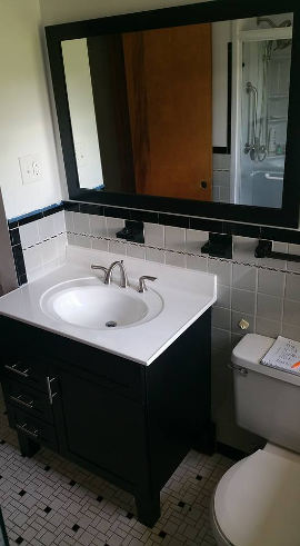 Black bathroom vanity and mirror