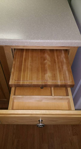 Cutting board hidden in custom cabinet drawer